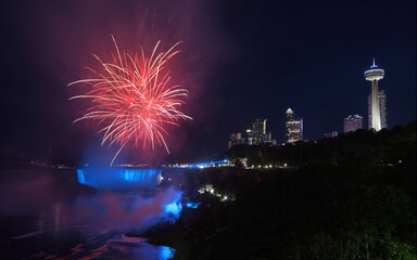 Niagara Falls skyline illuminated at dusk and fireworks, Canada