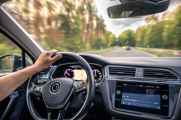 Car interior view. Motion blur highway driving. Steering at high speed.