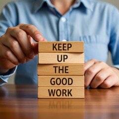 Encouragement: Wooden Blocks Spell "Keep Up The Good Work" on a Polished Table