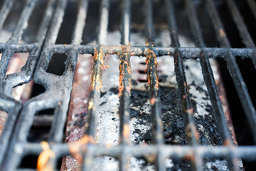 Macro view of dirty grate on gas grill