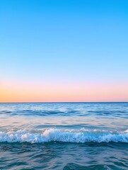 Serene ocean waves rolling towards the shore beneath a pastel pink and blue sky, creating a peaceful and tranquil atmosphere