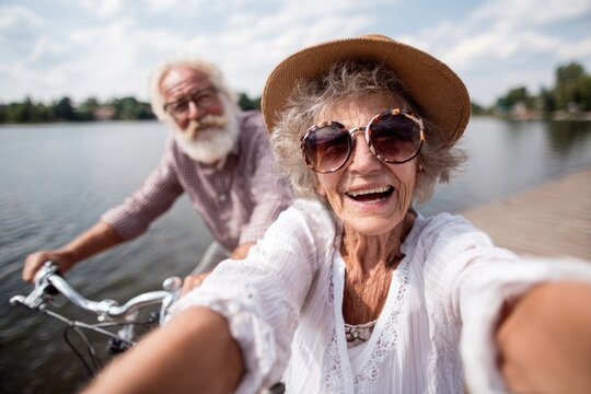 Happy senior couple taking selfie on bikes