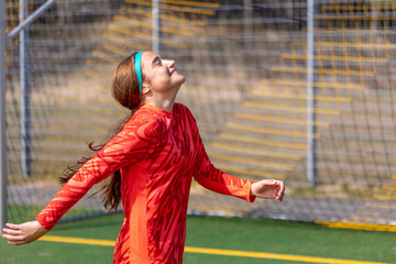 Girl soccer player. Girl in sports uniform on the soccer field. Football concept.