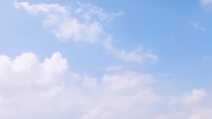 Blue sky background with white clouds in summer. Soft white clouds float in the clear blue sky. Focus on clouds. Full frame shot. Heaven sky bright blue sky background.