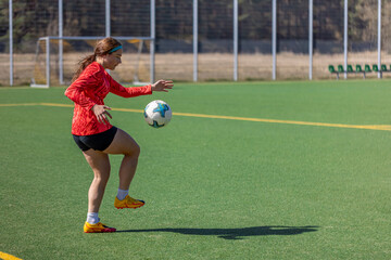 Girl on the soccer field. Soccer training. Active lifestyle. Football concept.