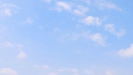 Blue sky background with white clouds in summer. Soft white clouds float in the clear blue sky. Focus on clouds. Full frame shot. Heaven sky bright blue sky background.