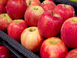 A close-up shot of a basket filled with fresh, ripe red and yellow apples