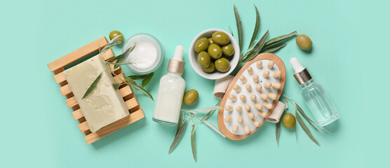 Composition with natural cosmetic products, massage brush and green olives on color background