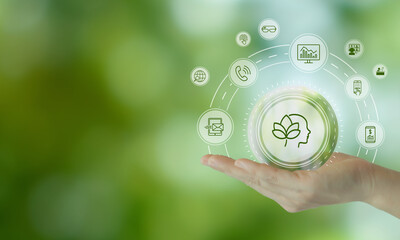Digital Wellbeing and Detox Concep. Holding a glowing digital interface with icons representing mental wellness on green background. Balance between staying connected and practicing digital detox.