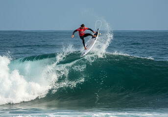 surfing on the sea,Surfer riding a wave, viewed from a low angle with spray.