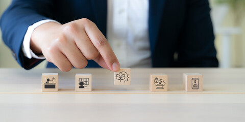 Digital wellbeing in workplace concept. Wooden blocks with icons representing digital wellbeing, healthy work-life balance. Promoting a healthy relationship with technology, encouraging mindful usage.