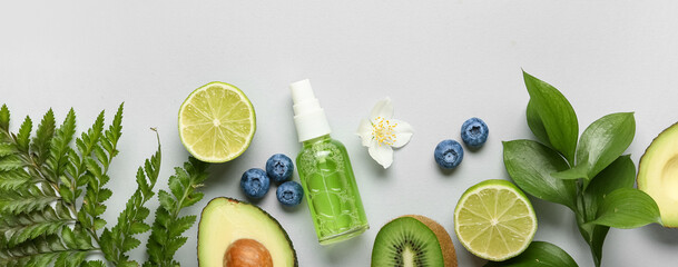 Natural cosmetic product, fruits and plants on grey background