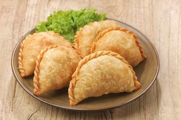 Pastel Goreng in Indonesia, pastel refers to a type of kue filled with meat, vegetables, and rice vermicelli deep fried in vegetable oil. It is consumed as a snack and commonly sold in Indonesian trad