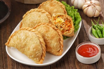 Pastel Goreng in Indonesia, pastel refers to a type of kue filled with meat, vegetables, and rice vermicelli deep fried in vegetable oil. It is consumed as a snack and commonly sold in Indonesian trad