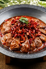 White porcelain plate with fried razor clam meat and rapeseed