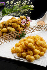Deep-fried small yellow croaker in an oval white porcelain plate