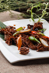 Scallion ribs on a square porcelain plate