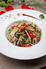 White round porcelain plate with spicy beef tongue