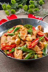 Stir-fried pork belly with mushrooms in a white rectangular porcelain plate