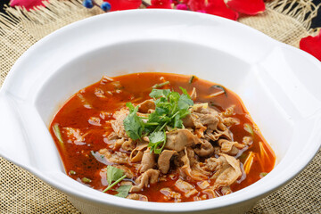Spicy beef stewed with sea sausage in a white porcelain soup bowl