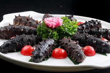 Seafood surf live sea cucumber sashimi in white square porcelain plate