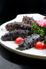 Seafood surf live sea cucumber sashimi in white square porcelain plate