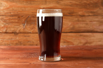 Glass of tasty kvass on wooden background