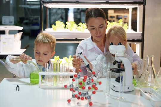 Kids and families have fun holding molecular models to learn about chemistry in the classroom, science lab. - Powered by Adobe