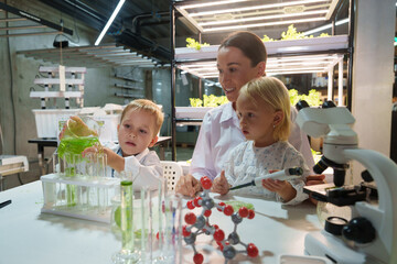 Kids and families have fun holding molecular models to learn about chemistry in the classroom, science lab.