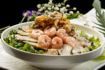 Three fresh seafood in sauce served on a white round porcelain plate