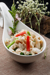 Sour soup bird shellfish in a spoon-shaped porcelain plate