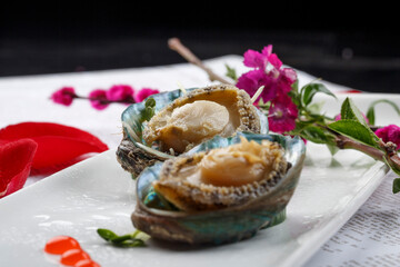 Seafood sashimi live abalone in rectangular white porcelain plate