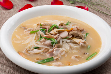 White round soup bowl with seafood and radish stewed with swan eggs