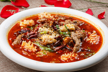 Boiled seafood with pork and blood in a white round porcelain plate