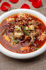 Boiled seafood with pork and blood in a white round porcelain plate