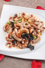 Fried octopus with XO sauce on a white square porcelain plate