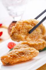 Fried chicken wings on a white porcelain plate