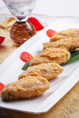 Fried chicken wings on a white porcelain plate