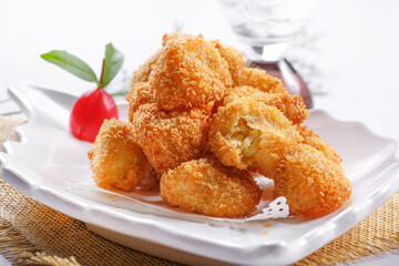 Fried chicken nuggets on white porcelain plate