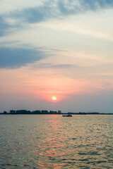fishing boats moving at sunset	