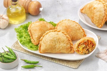 Pastel Goreng in Indonesia, pastel refers to a type of kue filled with meat, vegetables, and rice vermicelli deep fried in vegetable oil. It is consumed as a snack 