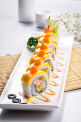 Golden crab roe sushi rolls are placed on the sushi curtain