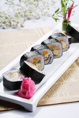 Assorted Tai-Maki sushi laid out on English wrapping paper