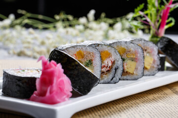 Assorted Tai-Maki sushi laid out on English wrapping paper