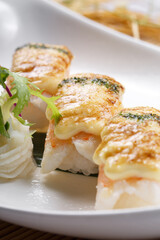 Cheese baked shrimp sushi placed on the sushi curtain
