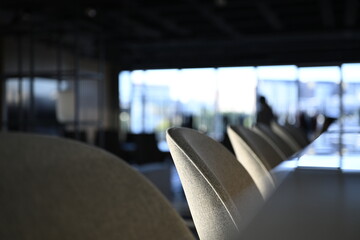 Bar stools and marble bar counter in a modern office interior with shallow depth of field and...