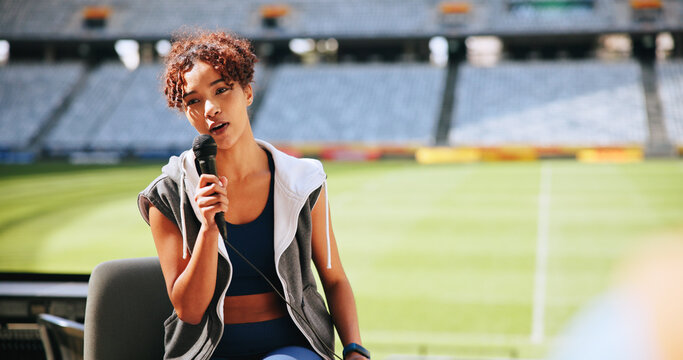 Athlete, mic and talking in interview at stadium for sports broadcast, media question and space. Public relations, television or woman speaking at press conference for game coverage or fan engagement