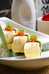 Miss Tamago's seaweed egg omelette sushi is placed on a straw mat