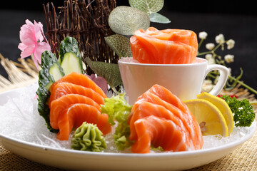 Salmon sashimi is placed on the grass mat