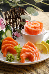 Salmon sashimi is placed on the grass mat